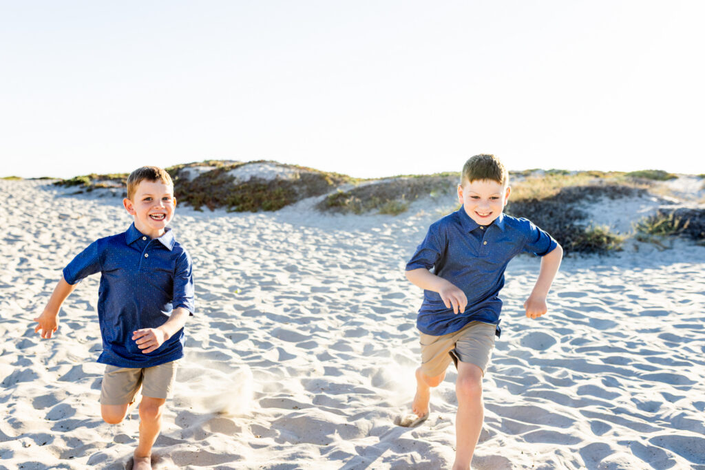 A Windy Evening with a Lifestyle Photographer San Diego Families Trust Family enjoying the ocean breeze during a lifestyle photography session in Coronado